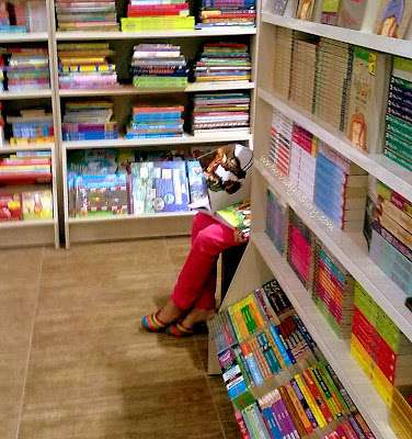 Life. Little girl in library