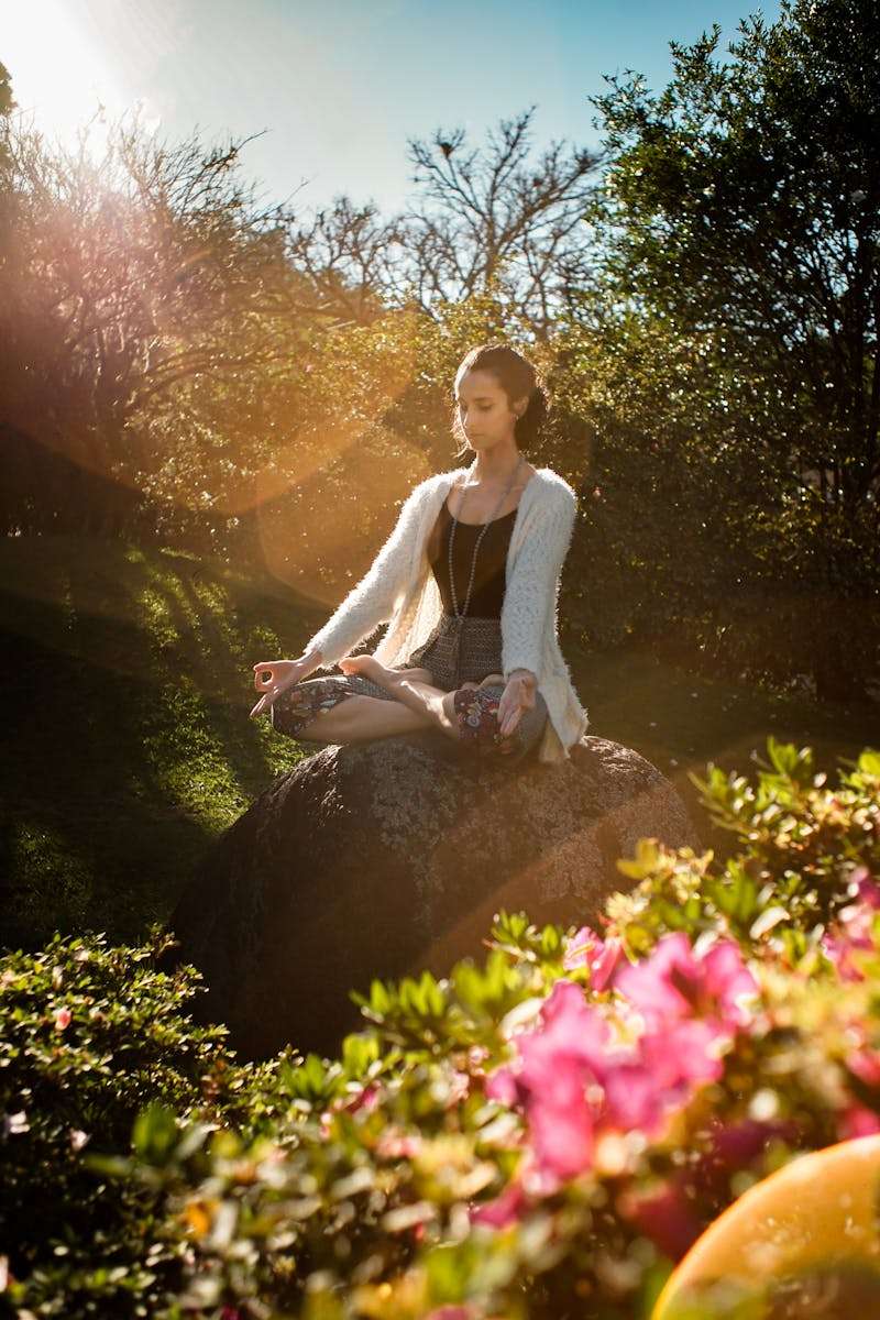 Meditation for headache Woman Meditating on Rock