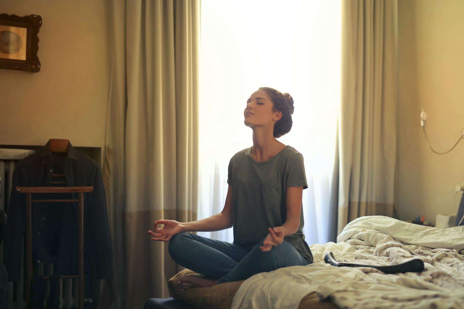 Meditation for headache Woman Meditating In Bedroom