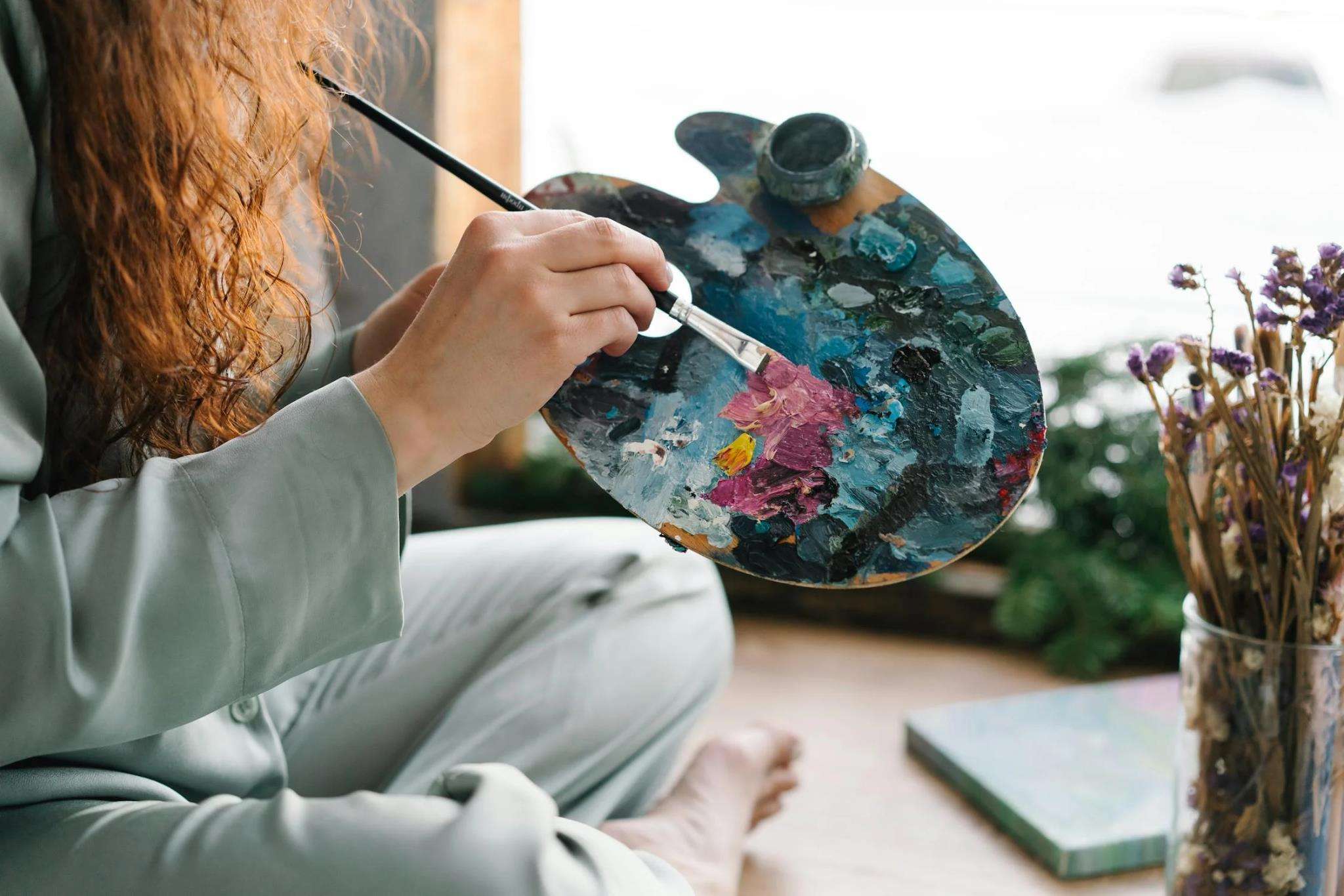 Woman's hand poised on a color pallette Boost your mind and body