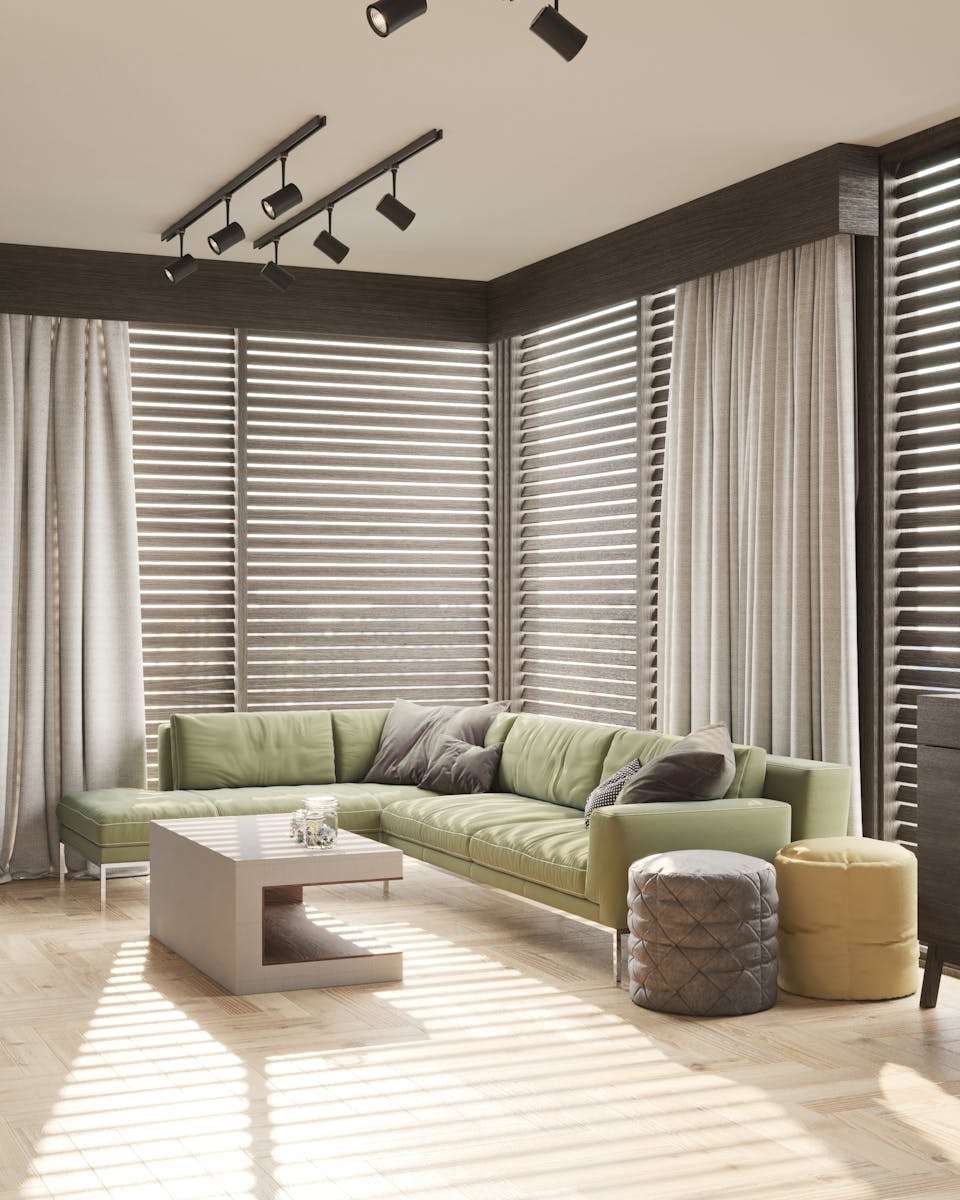 Sectional Sofas Bright living room with a green sofa, wooden blinds, and minimalist decor.