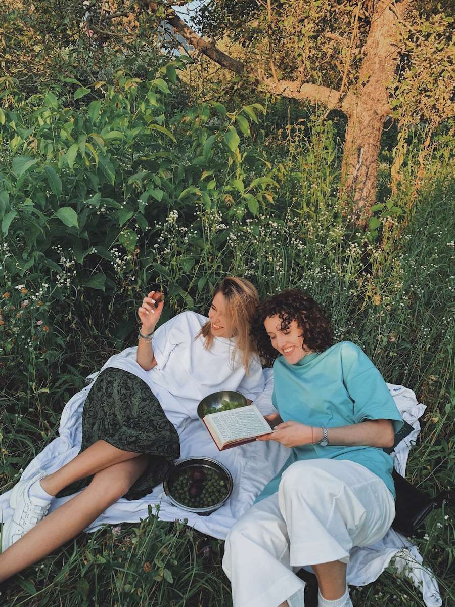 In person interactions man and woman sitting on white bed reading book