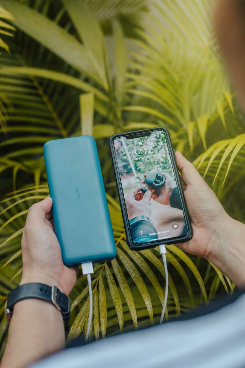 Everyday accessories black smartphone and green powerbank close-up photography