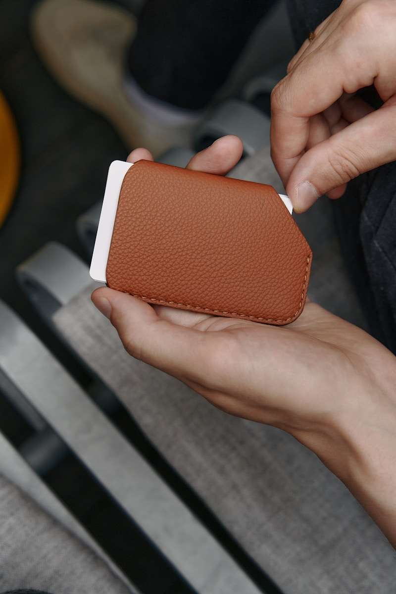 Everyday accessories a person holding a cell phone in their hand