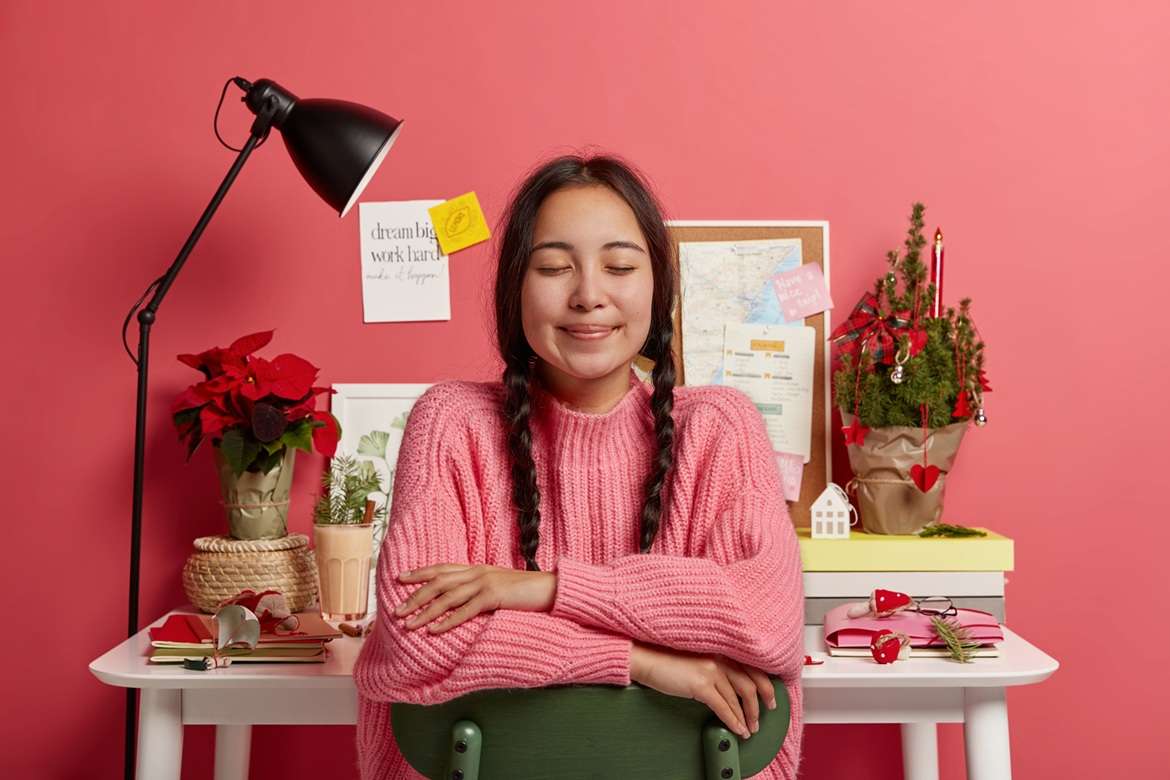 Gratitude practices Young teenage girl with eyes closed sitting in chair