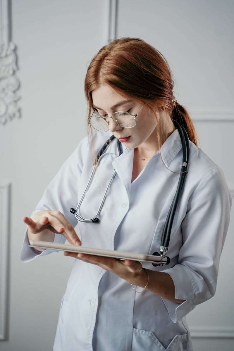 Medical records Female doctor using a tablet for medical diagnosis in a modern office setting.