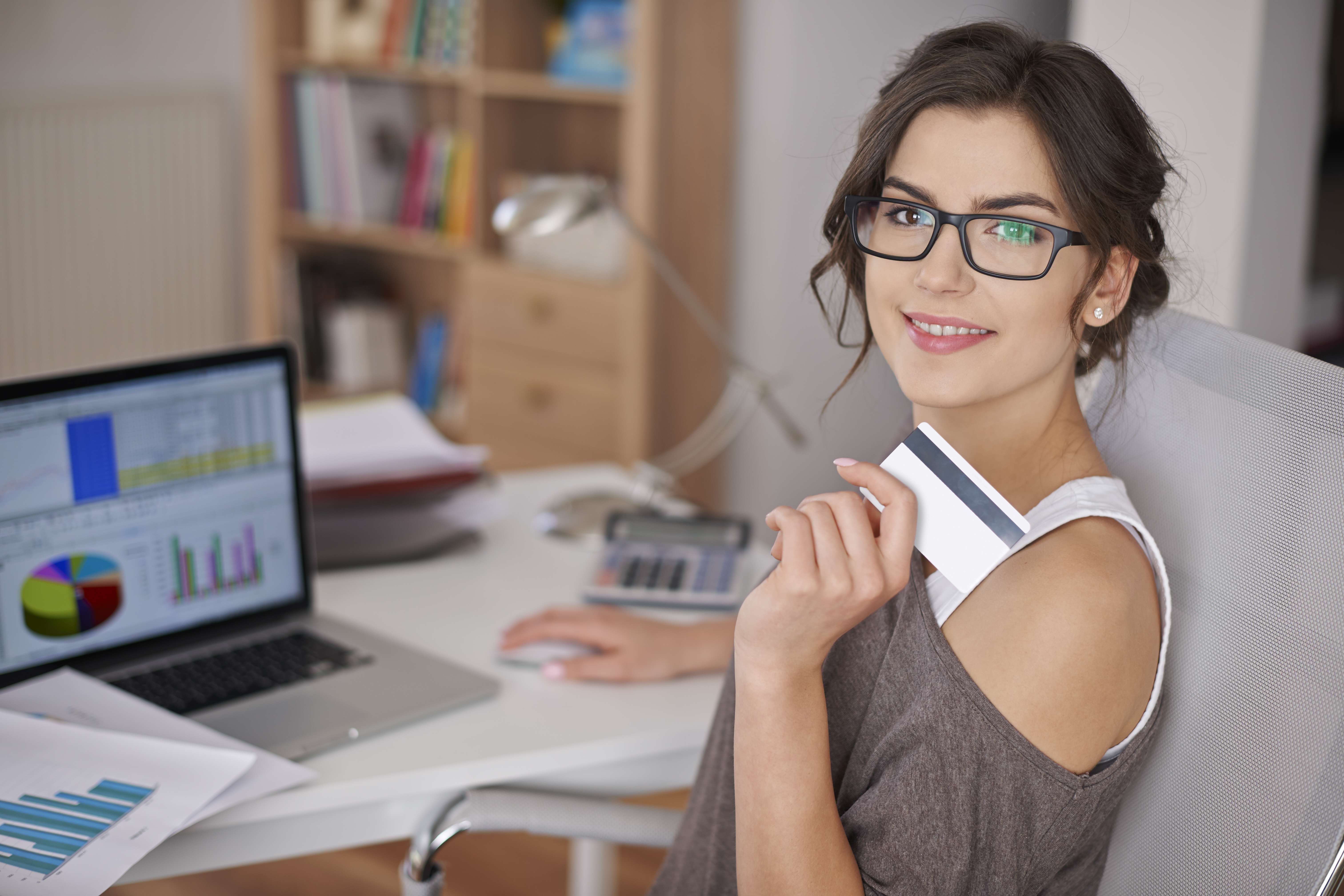 Financial stability - young woman in glasses smiling