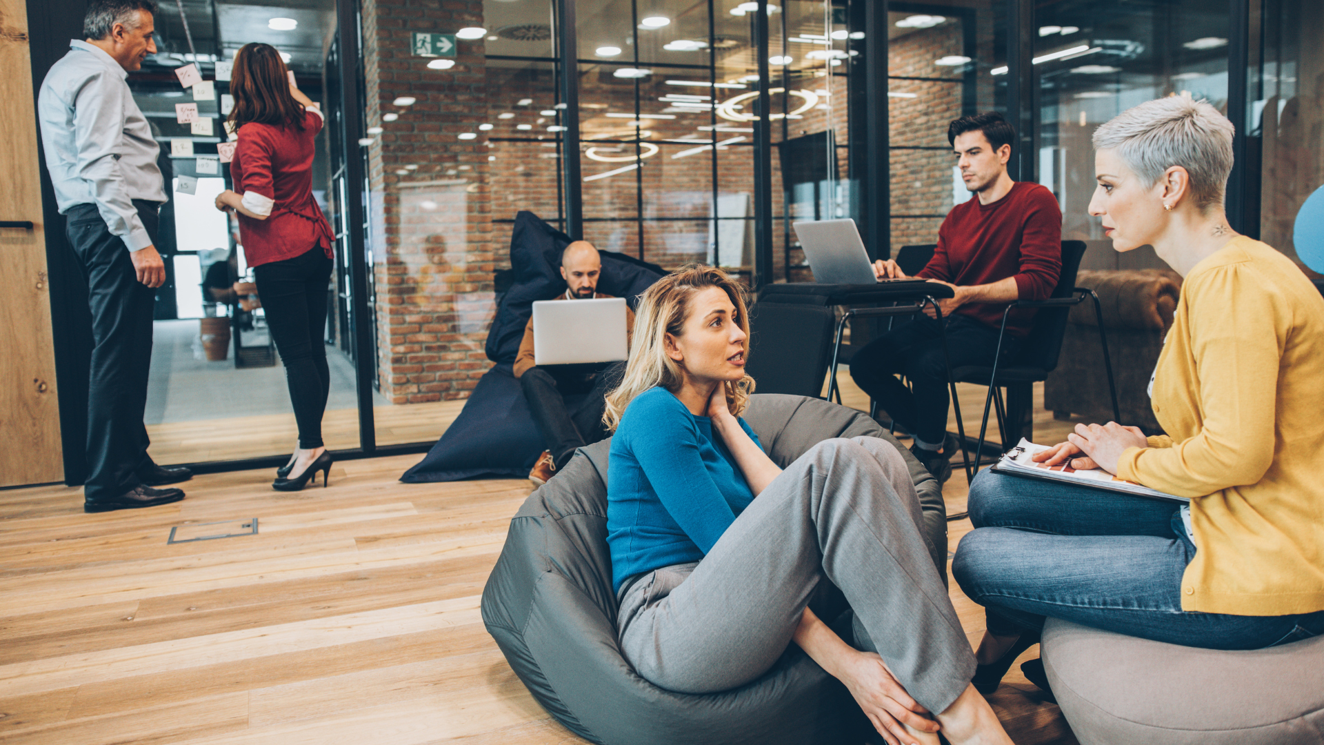 Coworking space features that can transform how you work. People sitting in a work area
