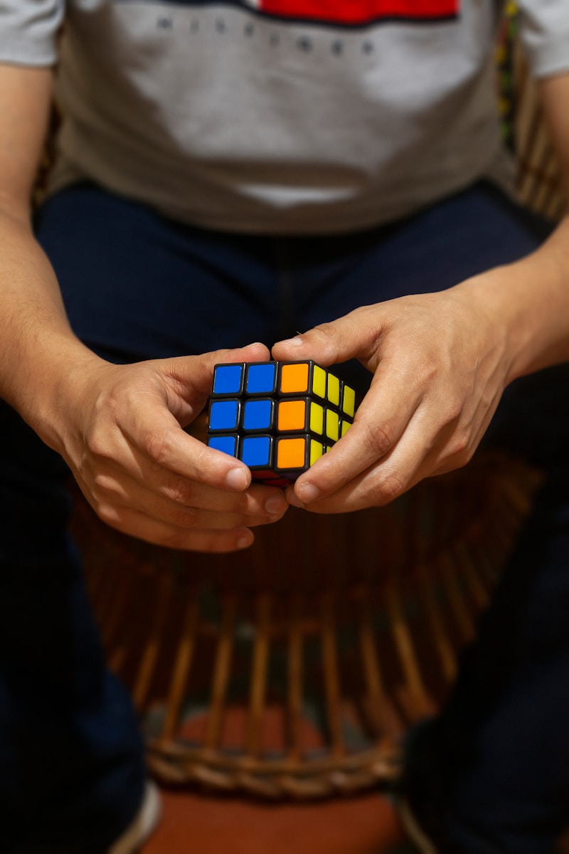 5 Benefits of Daily Puzzle Solving for Mental Fitness A person holding a rubik cube in their hands