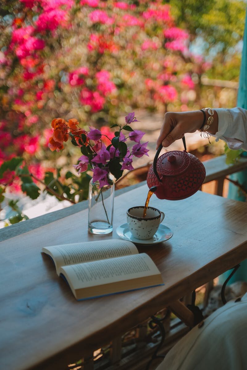 A Gentle Evening Dandelion Tea for Busy Days Relaxing tea scene with vibrant flowers and a book in Antalya, Türkiye.