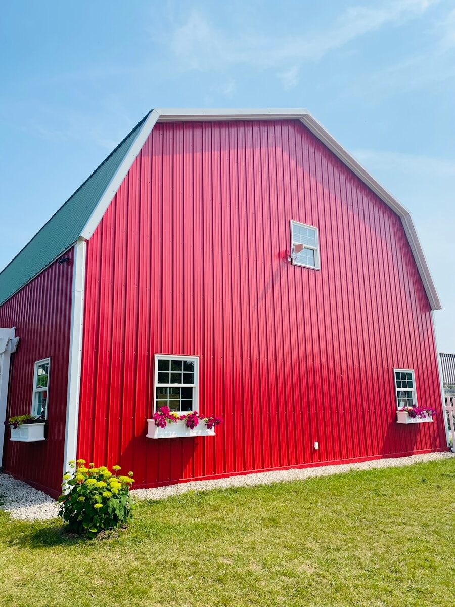 Is Timber-Frame Worth It? We Compared High-Quality Timber Frame Barns to Modern Prefab Options red wooden barn house near green trees during daytime