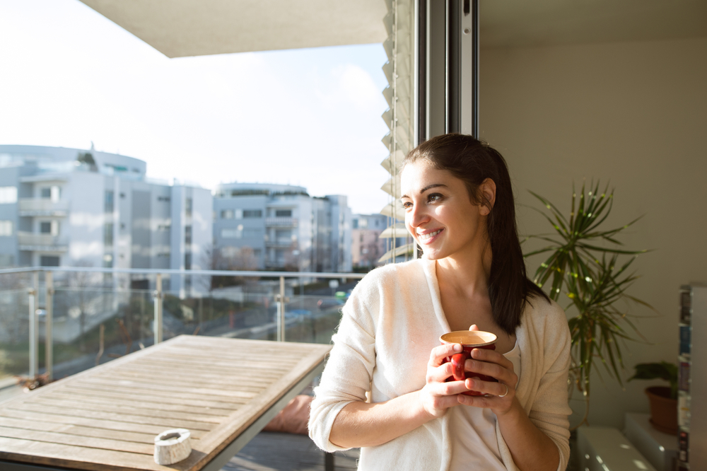 Appliances - Woman,Relaxing,On,Balcony,Holding,Cup,Of,Coffee,Or,Tea