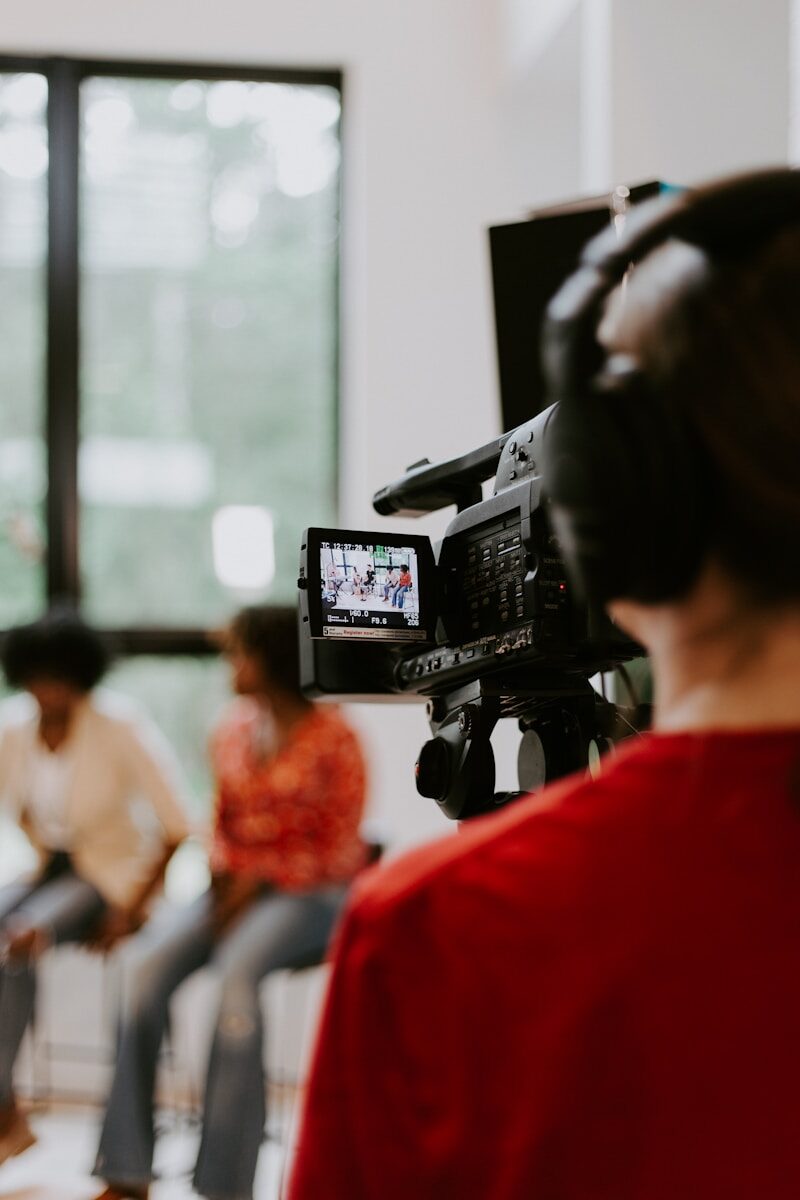 Capturing Life's Moments: Why Video Content Matters More Than Ever woman in red shirt holding black video camera