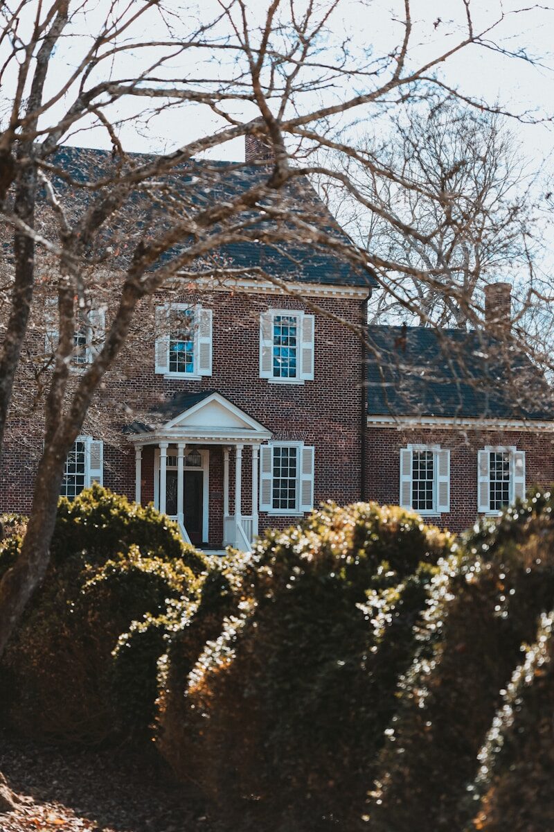 How to Fast-Track Your Garner Home Sale Successfully A large brick house surrounded by trees and bushes