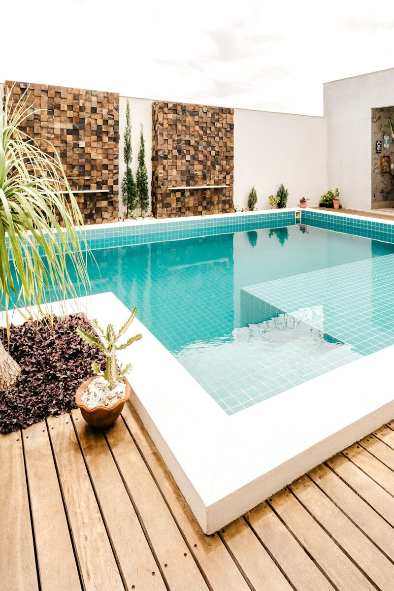 What to Know Before Hiring a Custom Pool Builder in Phoenix green potted plant beside swimming pool