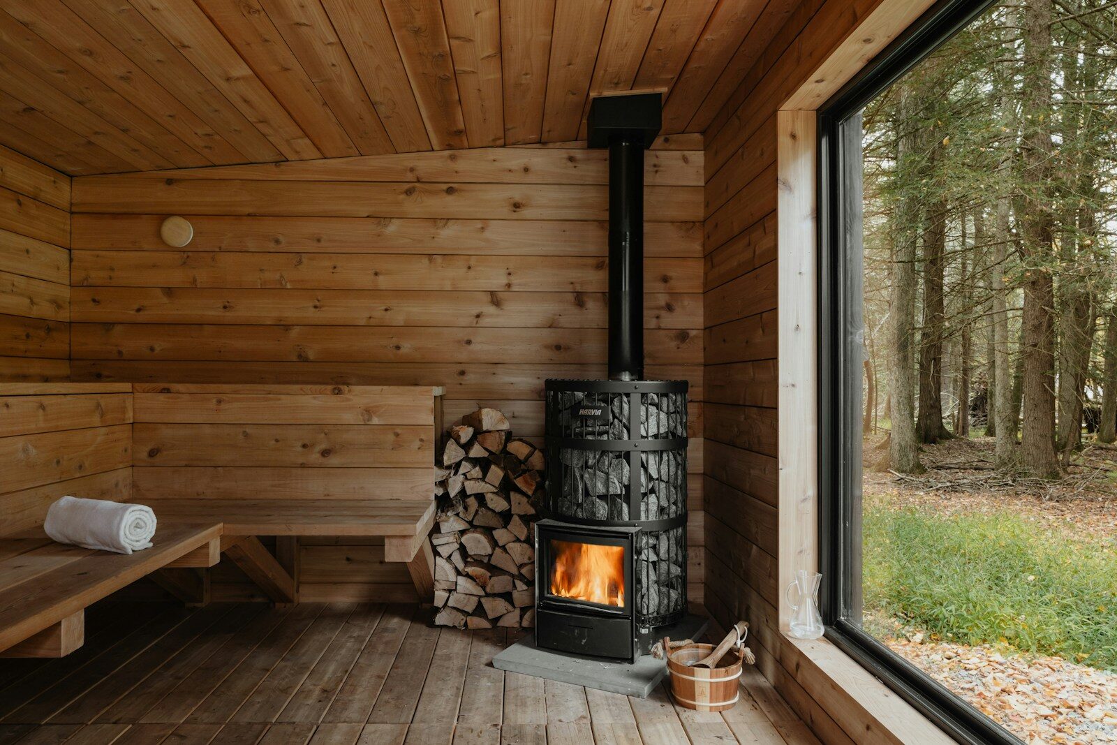 How Investing in New Sauna Collections Enhances Home Wellness A wood burning stove inside of a wooden cabin