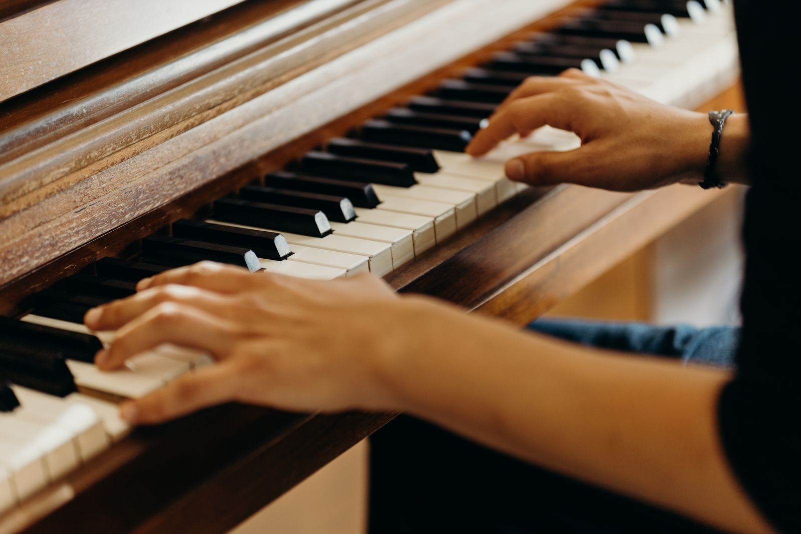 The Premier Choice for Piano Stores in Utah: Steinway Piano Gallery UtahHands playing a classical piano in a close-up shot, capturing the essence of musical expression.