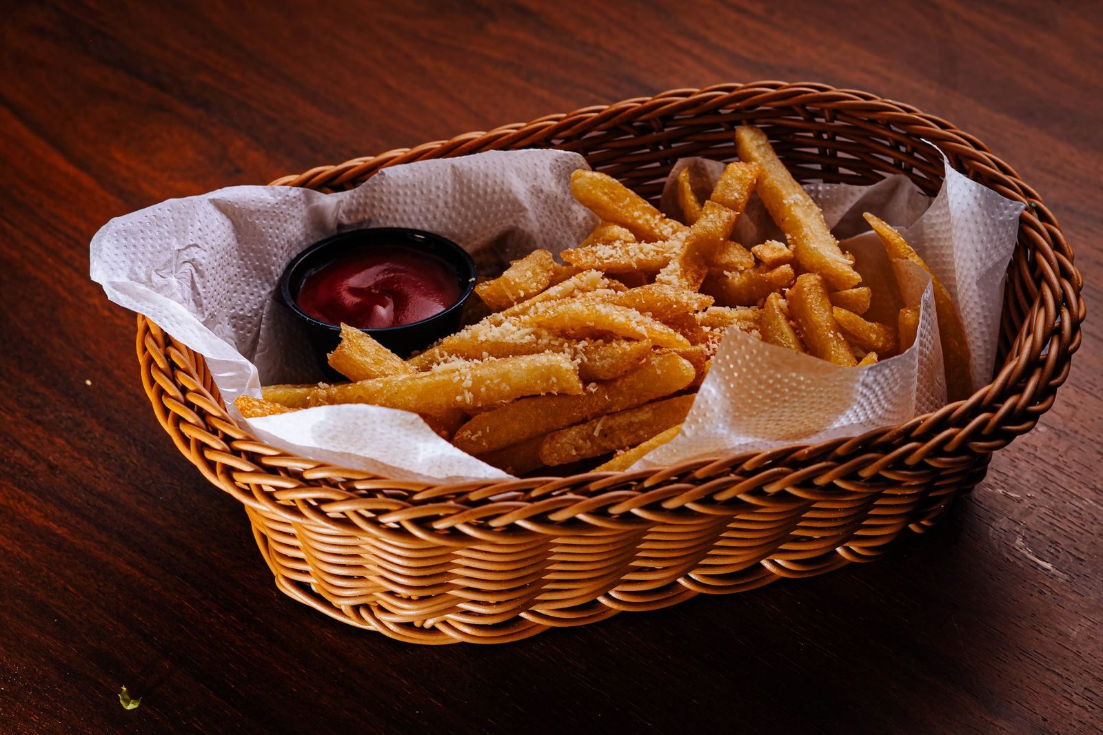 Air fryers kitchen essentials Delicious French fries with parmesan served in a basket with ketchup dip.