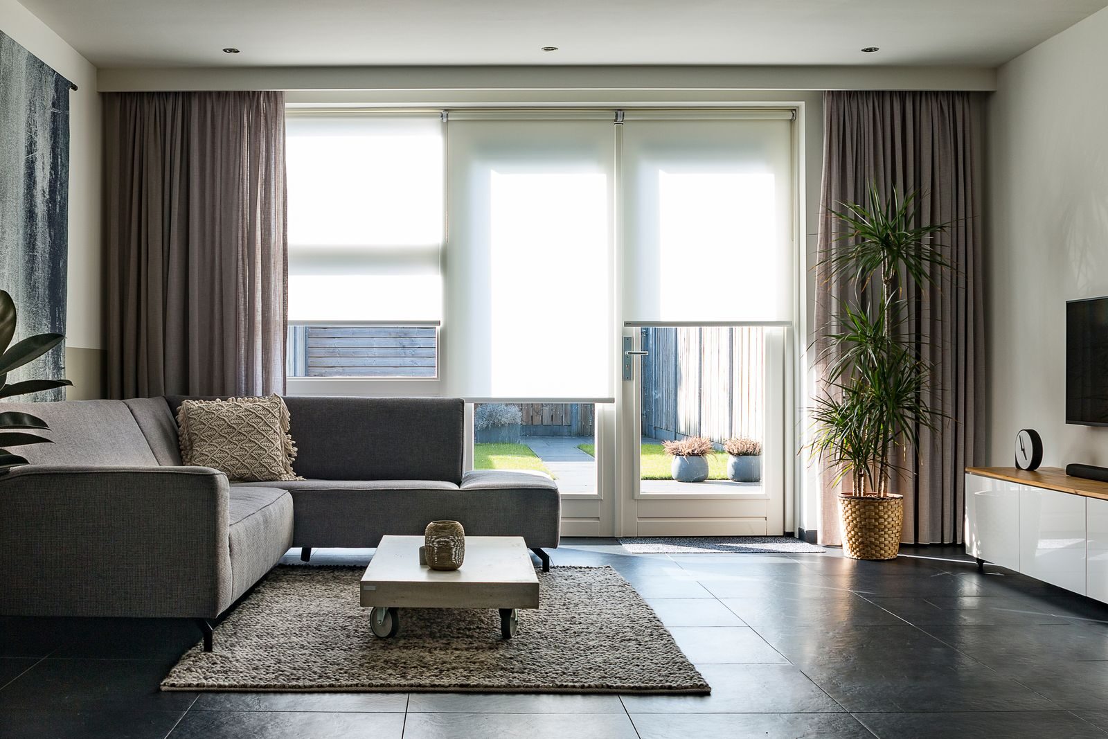 Maximizing Energy Efficiency with Window Treatments in North Dallas, TX A modern living room with sleek furniture, natural light, and minimalist decor.