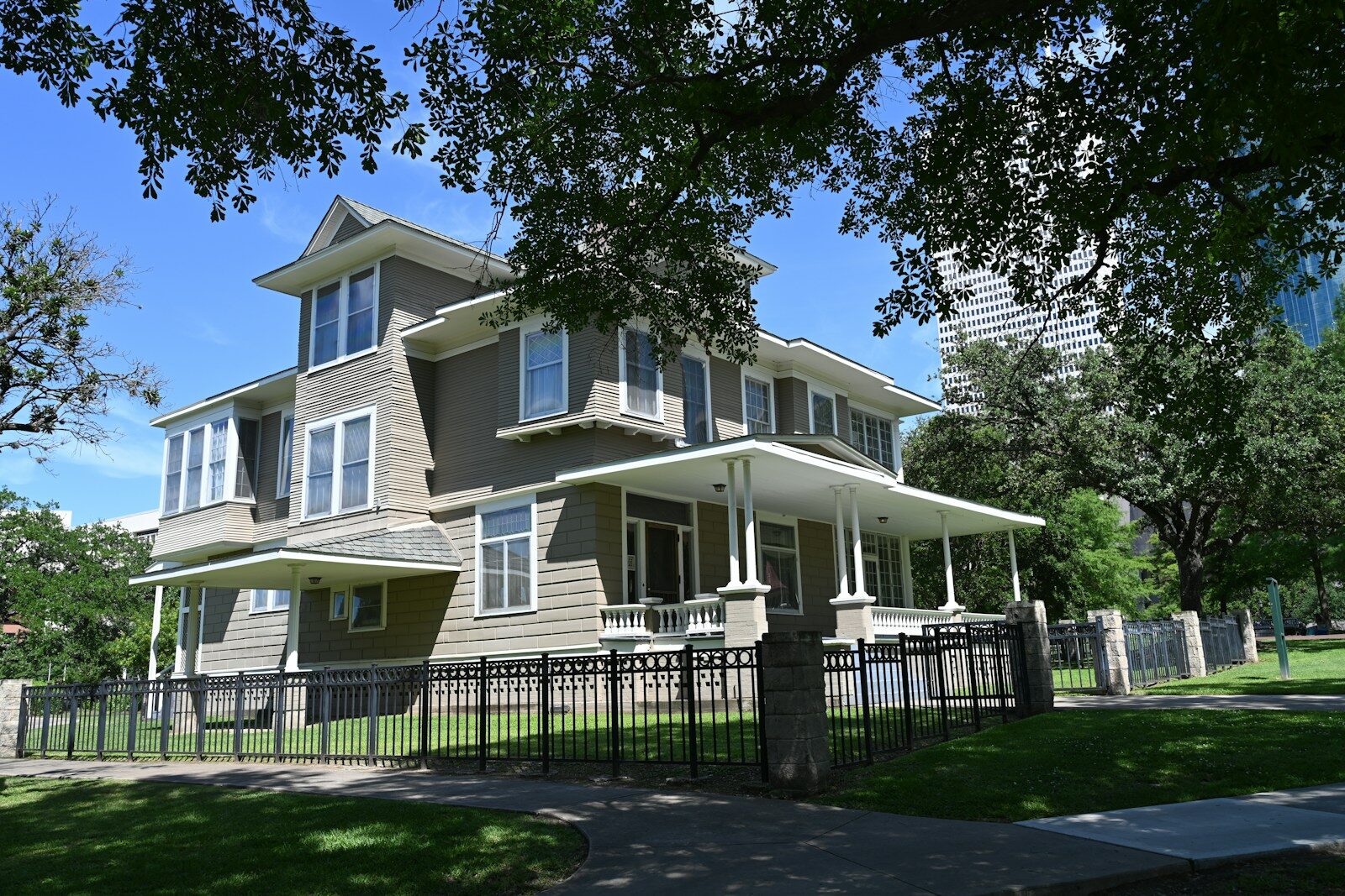 The Consequences of Leaving a House Unoccupied in Texas Beautiful, large house behind a fence and trees.