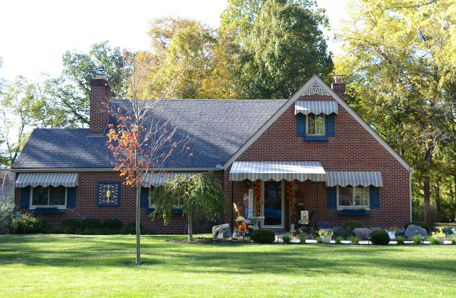 Buying a Home in Fredericksburg, VA: A Comprehensive Guide for Homebuyers A brick house with a green lawn and trees.