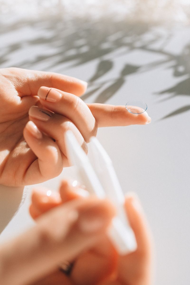 Daily vs Monthly Contact Lenses: A Physiology-Based Guide to Choosing What's Right for Your Eyes Detail shot of a contact lens on finger with natural light creating shadows, perfect for eyewear symbolism.