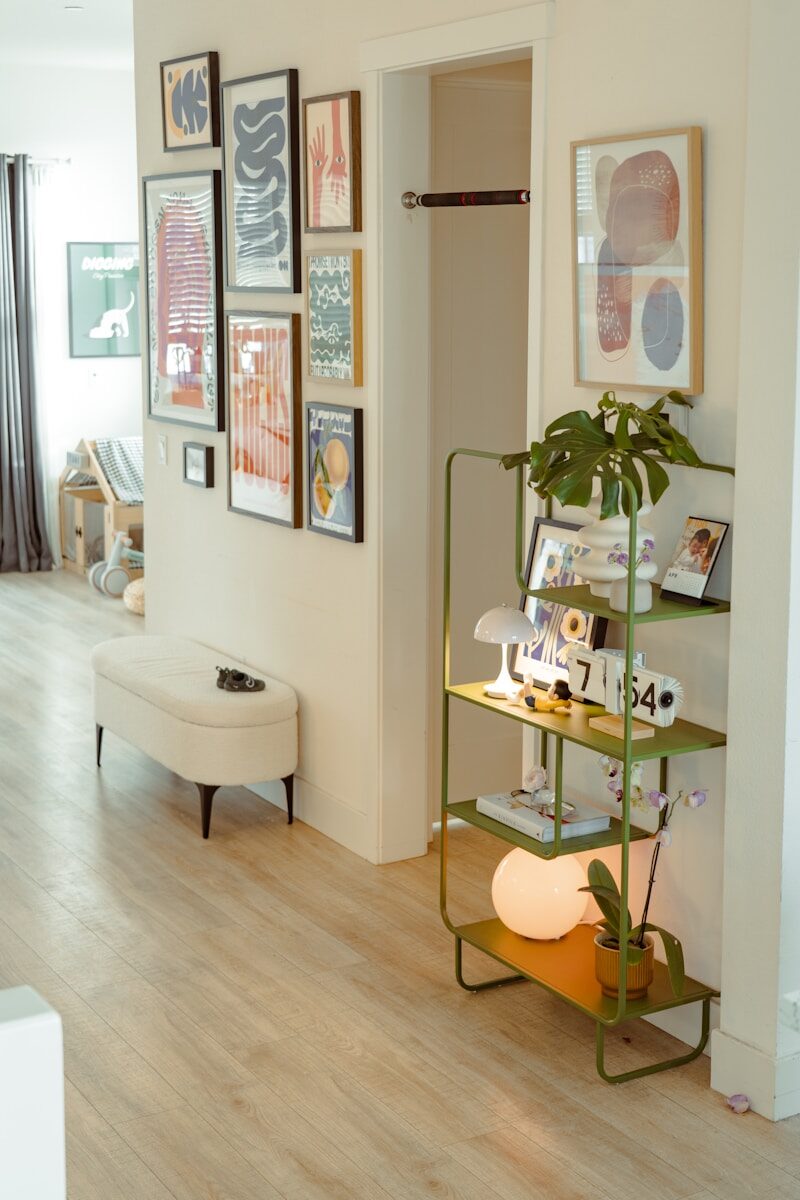 The Calm Home Checklist: Small Repairs That Quiet a Room Hallway with art, bench, and green shelf.