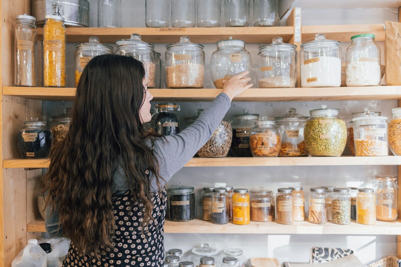 Food Storage Basics For Busy Households a person holding a jar of food