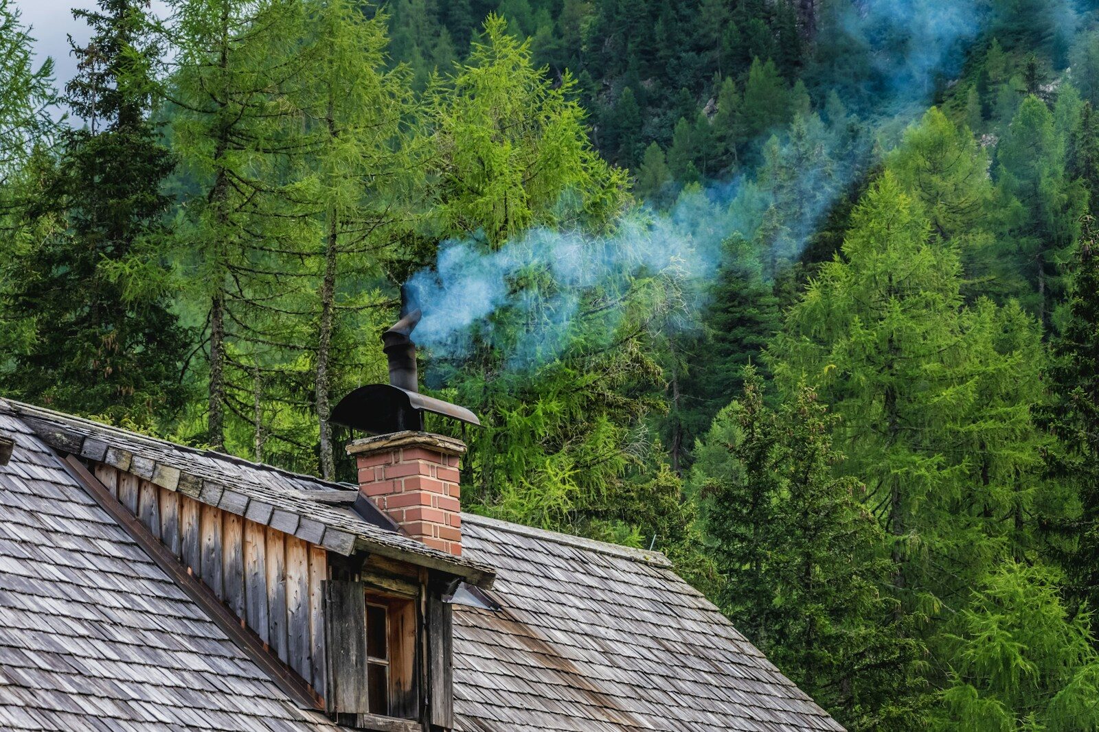 Summer Chimney maintenance brown wooden house near green trees during daytime