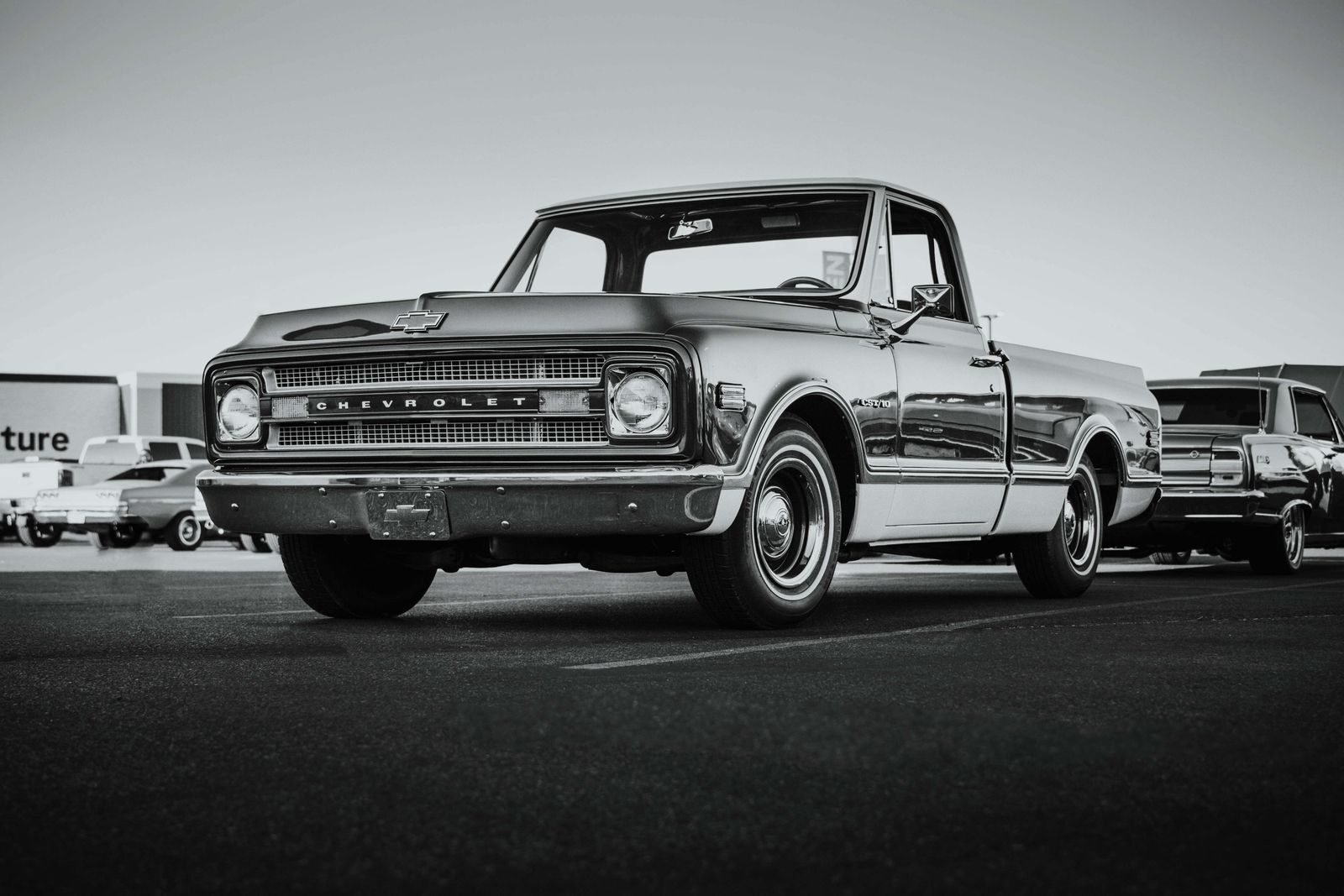 Yoba Falcon: An Automotive Enthusiast’s Take on What Keeps Chevy Trucks a Favorite Among Drivers Classic Chevrolet pickup truck parked in a Las Vegas parking lot. Captured in vintage style.
