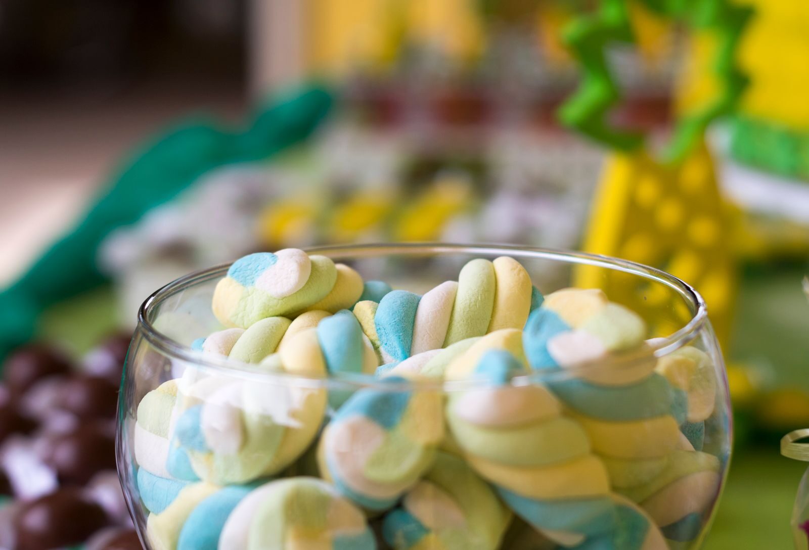self talk Colorful twisted marshmallows in a glass bowl, perfect for candy-themed decor