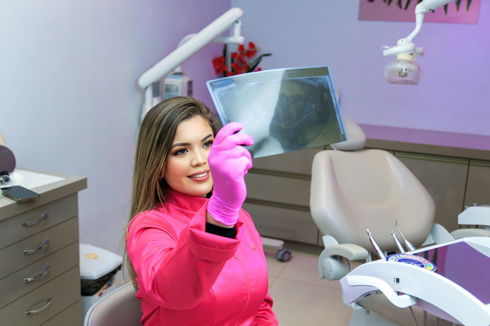 Can a Dental Savings Plan Help You Afford Regular Dental Visits? a woman sitting in a dentist chair holding up an xray
