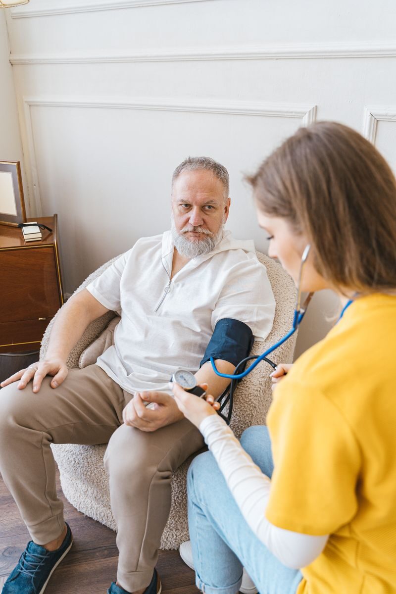 7 Best In-Home Care Services for Seniors in Dallas - Fort Worth (2026) An elderly man having his blood pressure checked by a nurse during a routine health checkup indoors.