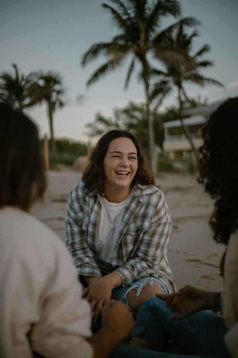 Working From Home While Prioritizing Mental Health: A Practical Recovery Guide a group of people sitting on top of a sandy beach