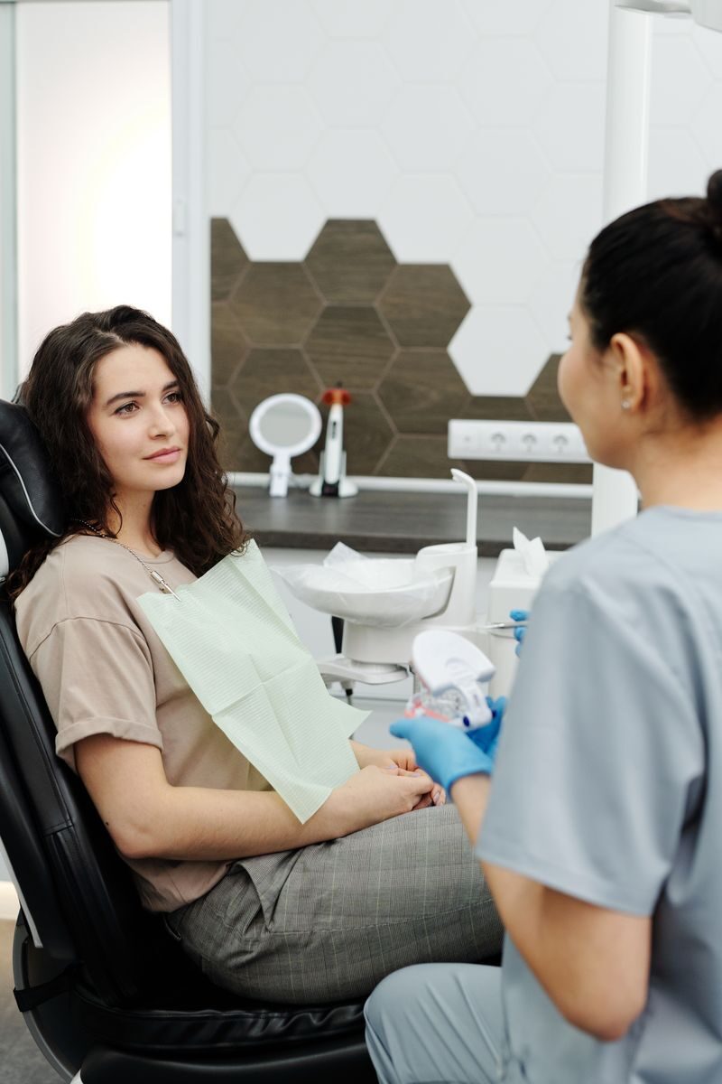 Dentures and the Emotional Side of Restoring a Complete Smile A dentist and patient in a modern clinic during a dental consultation.