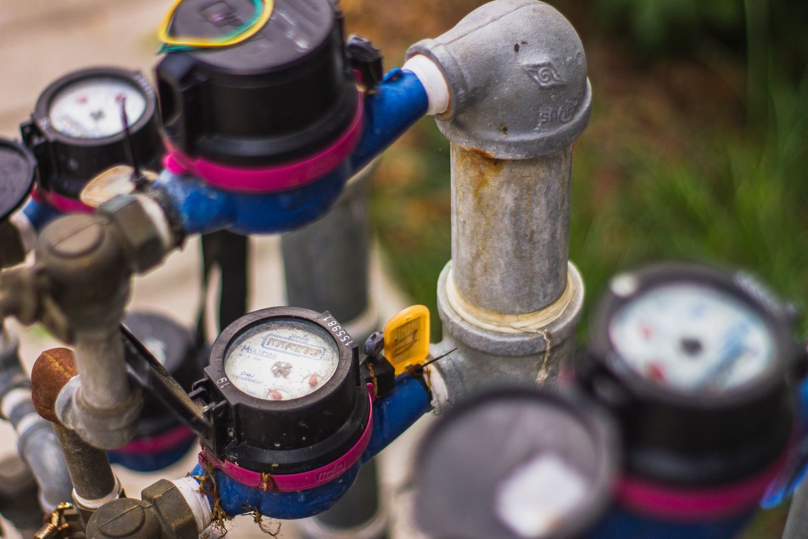 Backflow Prevention for Businesses: Annual Compliance Guide for Commercial Property Managers Detailed image of industrial water pressure gauges and pipes in an outdoor setting.