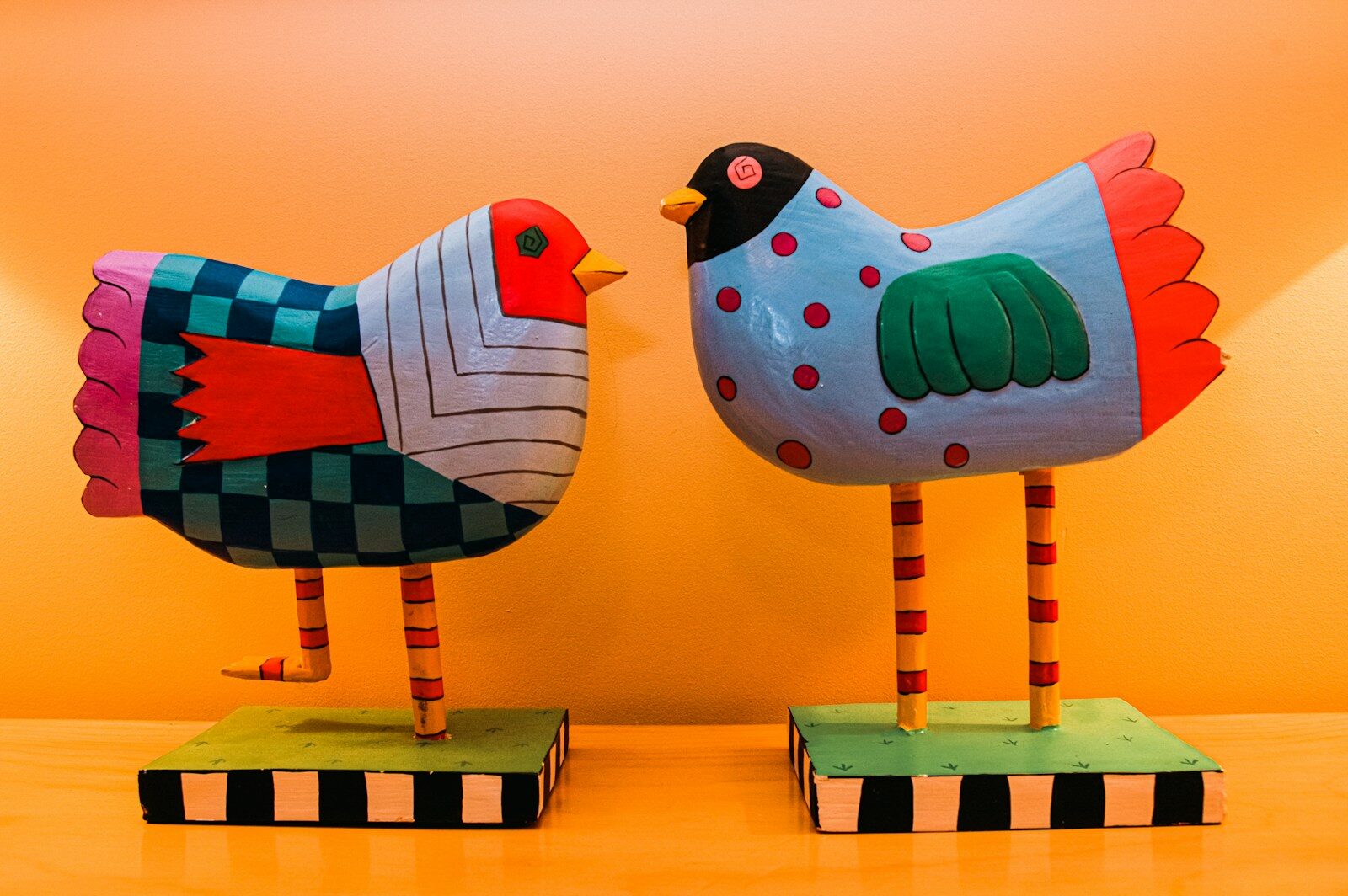 Animal art in cozy interior design a couple of wooden birds sitting on top of a table