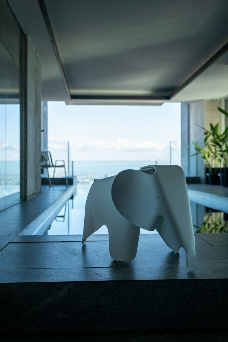 Animal art in cozy interior design a white elephant statue sitting in front of a swimming pool